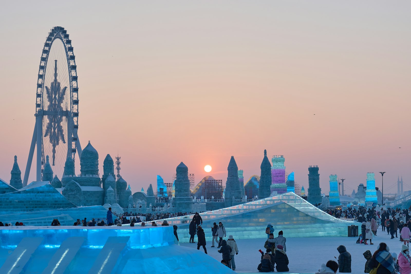 Visitors gathered around an illuminated ice sculpture in Harbin
